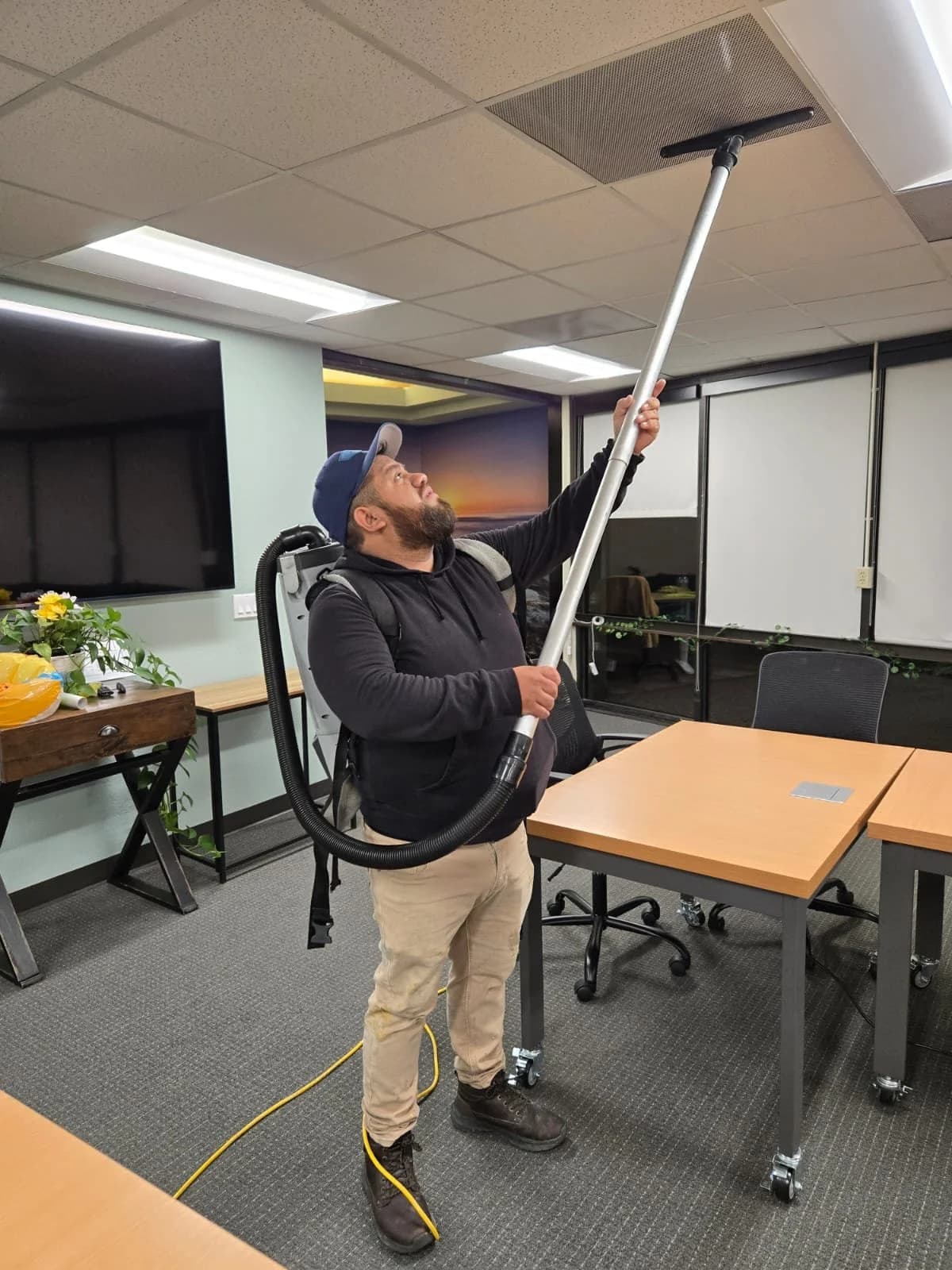 Oracle Group Services technician deep cleaning office ceiling