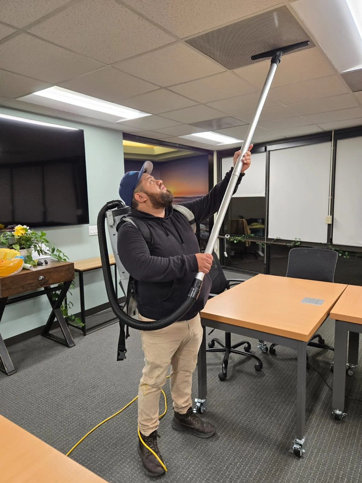 Oracle Group Services technician deep cleaning office ceiling